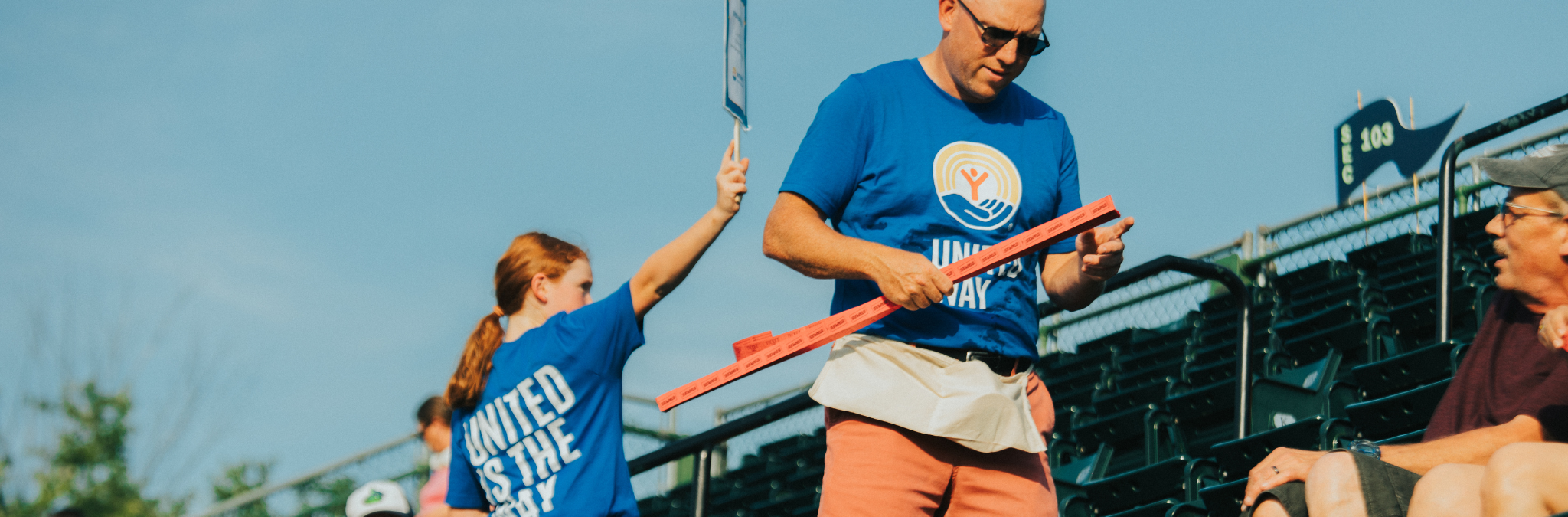 Volunteers sell 50/50 raffle tickets for United Way at a Lake Monsters game