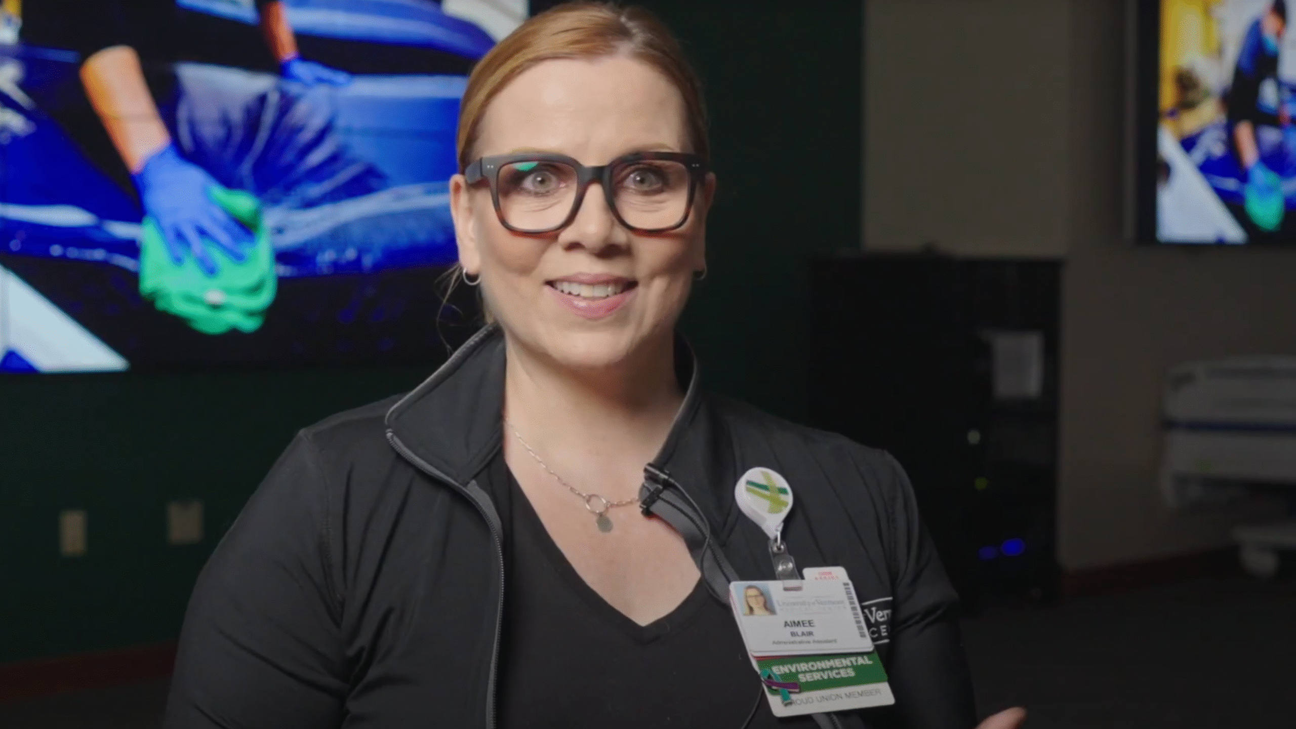 A screenshot from a talking head interview with UVM Medical Center employee Aimee Balire. She smiles while looking into the camera