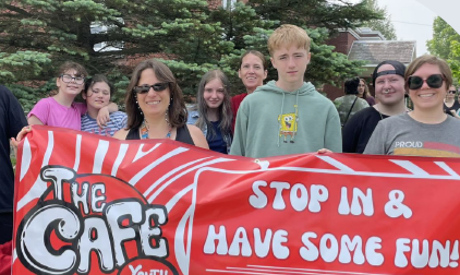 Youth marching with a banner for the Enosburg Youth Cafe 